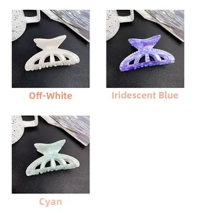 Close-up of marble texture acrylic hair claws in creamy white, iridescent blue, and cyan