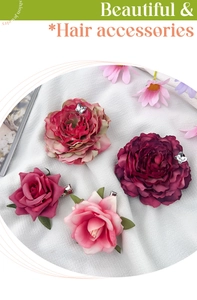 Detailed macro view of artificial peony and rose hair clips with silk butterfly accents