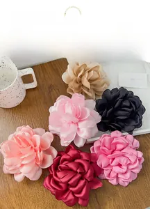 Vue macro détaillée de six épingles à cheveux fleurs en soie sur une table en bois