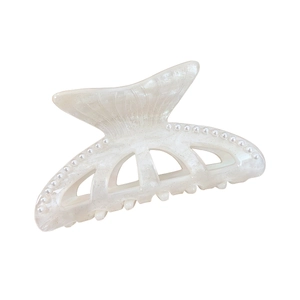 Elegant fishtail hair claw with pearl accents and shimmering white acrylic finish