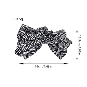 Elegant fabric bow scrunchie with black and white chevron pattern for women
