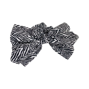 Elegant fabric bow scrunchie with a stylish black and white zebra pattern for hair styling