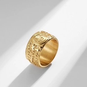 Macro detail of sun moon star engraving on wide textured vintage stainless steel ring