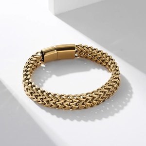 Polished gold double-weave stainless steel bracelet with square magnetic clasp on white stand