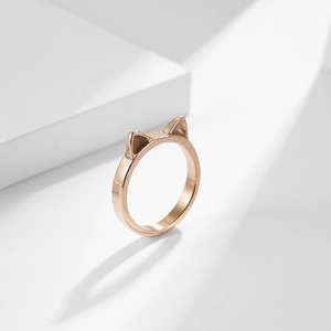 Minimalist rose gold cat ear ring for women with polished surface on white pedestal