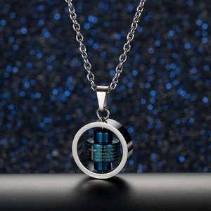 Macro shot of rotatable blue cylinder pendant with engraved cross and hiphop scripture