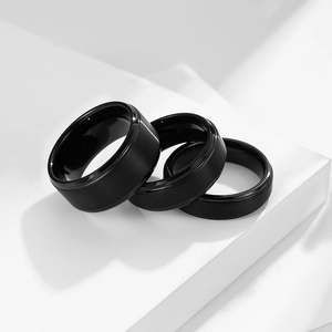 Three-piece set of matte black tungsten steel rings in various widths on white display