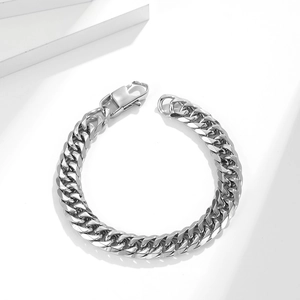 Minimalist silver stainless steel Cuban link bracelet with lobster clasp on white background