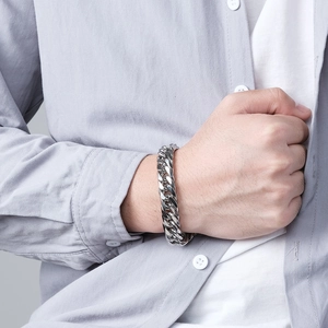 Neutral stainless steel Cuban link bracelet for men on wrist with silver metal finish
