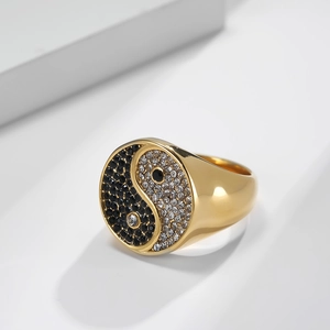 Polished gold tai chi ring featuring yin yang pattern with black and white crystals
