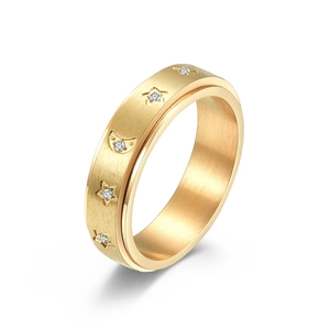 Gold rotatable fidget ring with star and moon patterns and sparkling cubic zirconia