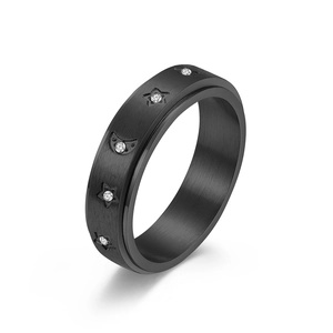 Black matte spinner ring with rotating moon star pattern and tiny inlaid diamonds