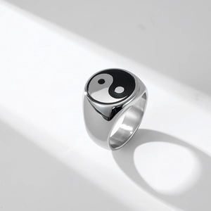 Macro shot of polished silver stainless steel signet ring with black and white Tai Chi Yin Yang
