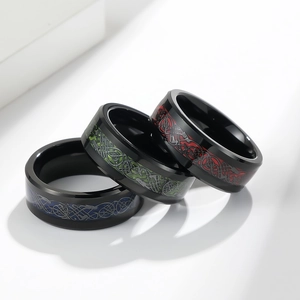 Detailed macro view of black tungsten rings with colorful dragon celtic carbon fiber inlay