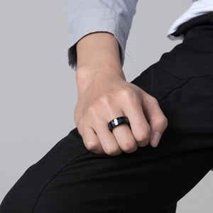 Men's black tungsten steel ring with blue dragon inlay pattern shown on a hand
