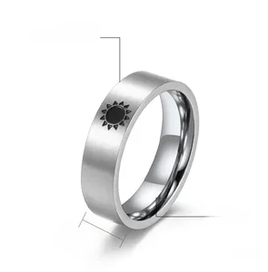 Detail view of 6mm matte black stainless steel ring with sun engraving and brushed finish