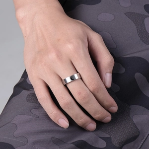 Matte silver stainless steel moon and star ring shown on male model's finger