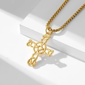 Detail of gold Celtic knot cross necklace featuring complex cut-outs and box chain link
