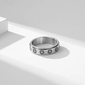 Rotating stainless steel anxiety ring with engraved smiley face patterns in silver finish