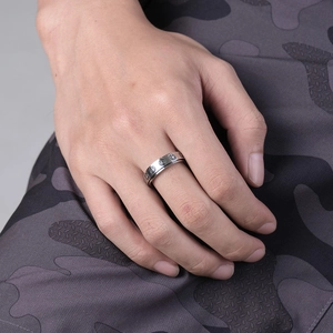 Neutral spinning stainless steel ring with engraved smile faces for anxiety relief