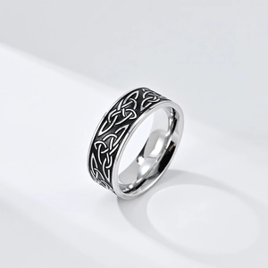Close-up of a silver Celtic knot ring with black vintage finish on polished steel