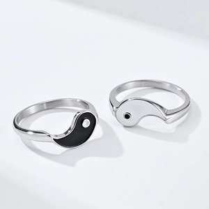 Detailed close-up of complementary Tai Chi Yin Yang split rings in polished steel