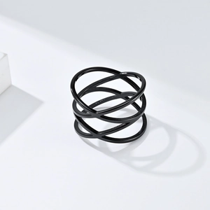 Macro detail of black stainless steel cross hollow ring with multi-layer line design
