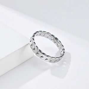 Polished silver stainless steel ring with geometric triangle hollow design on white platform
