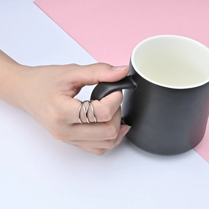 Silver minimalist triple-layered crossover stainless steel ring for women shown on finger