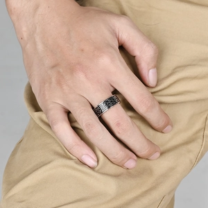 Men's vintage stainless steel Celtic knot ring with black oxidized finish on model