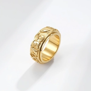 Detail shot of golden rotatable ring showing intricate 3D cat relief and matte finish