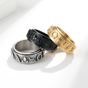 Three-piece Egyptian totem spinner rings set in silver, black, and gold stainless steel