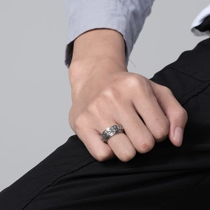 Vintage stainless steel spinner ring with ancient symbols on male model hand
