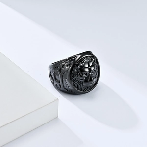 Vintage black stainless steel lion head ring for men on a white geometric stand