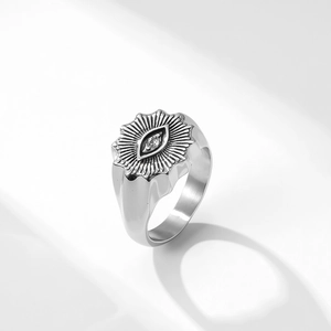 Macro detail of silver stainless steel signet ring with evil eye and clear zircon stone