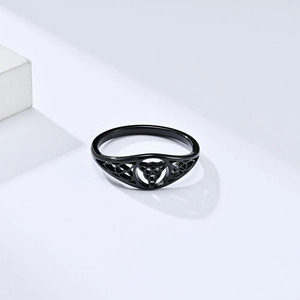 Minimalist black stainless steel Celtic Triquetra knot ring on a white stone base