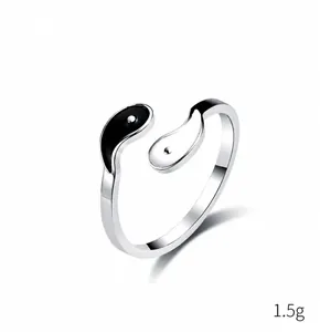 Macro detail of 2mm stainless steel yin yang ring with polished finish and black white enamel