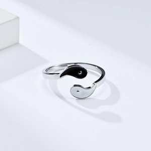 Detail of Yin Yang Tai Chi open ring with black and white drip oil fish design and silver finish