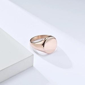 Polished rose gold stainless steel signet ring with a minimalist round flat top surface
