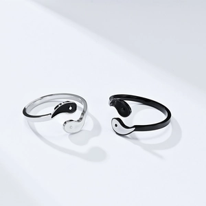 Detailed view of Yin Yang Tai Chi rings in black and silver adjustable stainless steel