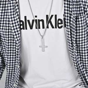 Polished silver stainless steel inverted St. Peter cross necklace worn by model