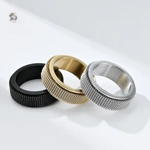 Three stackable rotatable stainless steel rings with knurled texture in black, gold, and silver