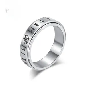 Macro detail of silver stainless steel viking ring with engraved runes and vegvisir symbols