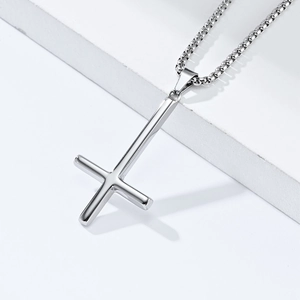 Detailed view of mirror-polished silver inverted Saint Peter cross pendant on box chain