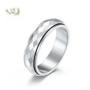 Macro detail of silver geometric faceted spinner ring in stainless steel for anxiety relief