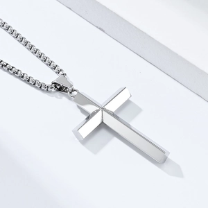 Detailed macro view of the polished silver rhombus cross pendant with box chain