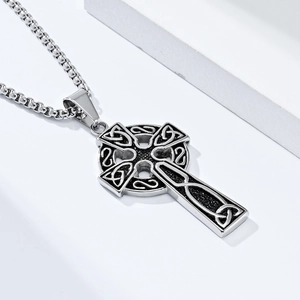 Detailed close-up of retro stainless steel Celtic knot cross pendant with distressed silver finish