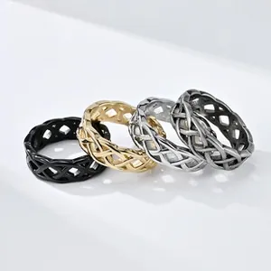 Detailed view of four spinner rings in black, gold, silver and vintage silver finishes