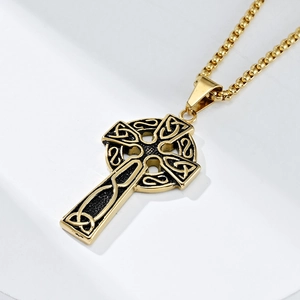 Detailed macro shot of vintage gold Celtic knot cross pendant with blackened textures