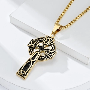 Vintage gold Nordic Viking Celtic cross necklace in stainless steel on white pedestal